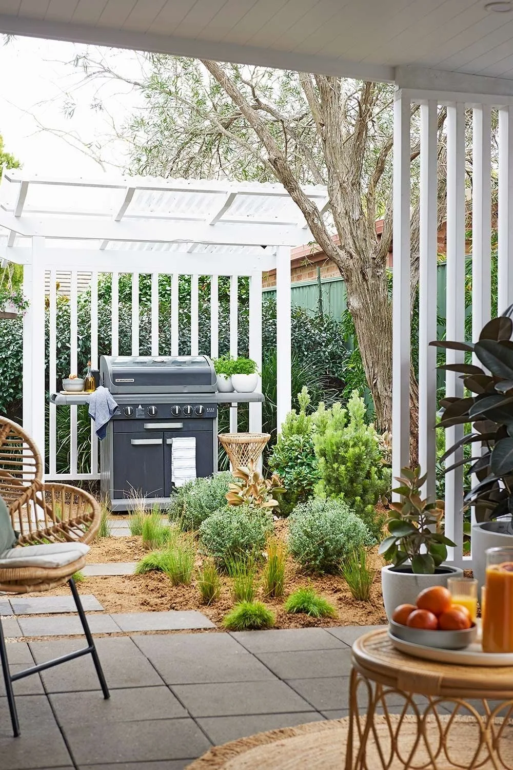 Barbecue underneath a shelter with timber screens