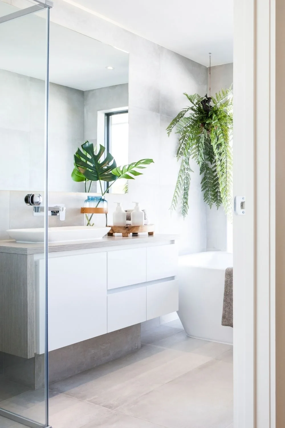 White bathroom with hanging indoor plant