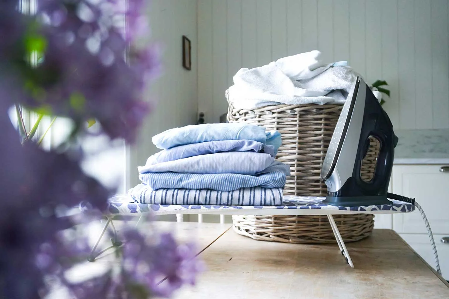 Ironing board with folded clothing on top