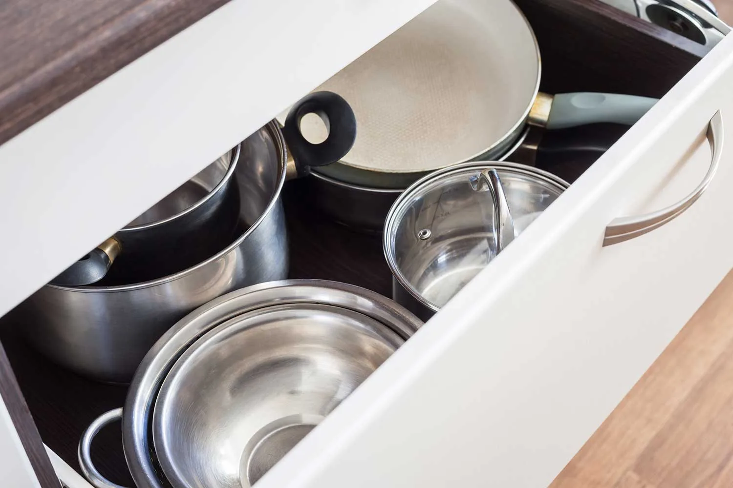 Shiny pots and pans in a drawer