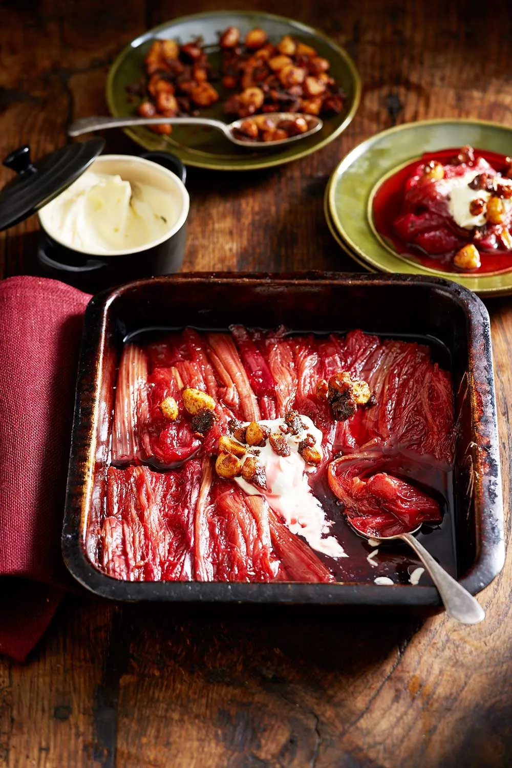 stewed rhubarb with dollop of cream still in oven tray