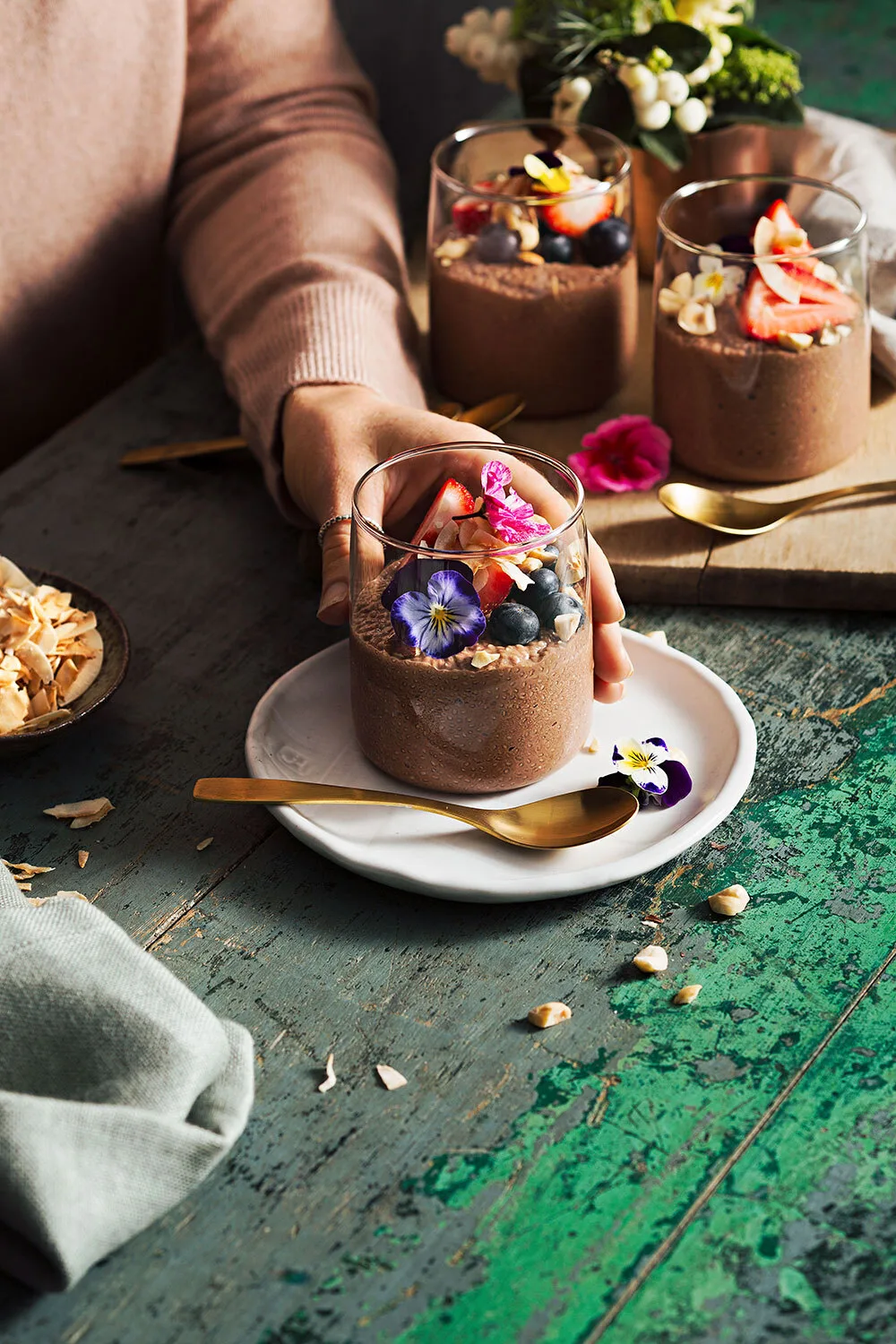 Choc hazelnut chia pudding with blueberries and edible flowers