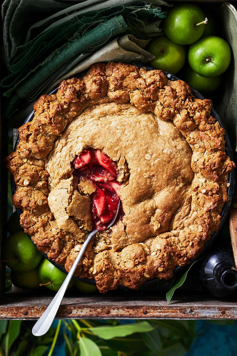 pie with thick oat crumbly crust and spoon dipping into middle of pie