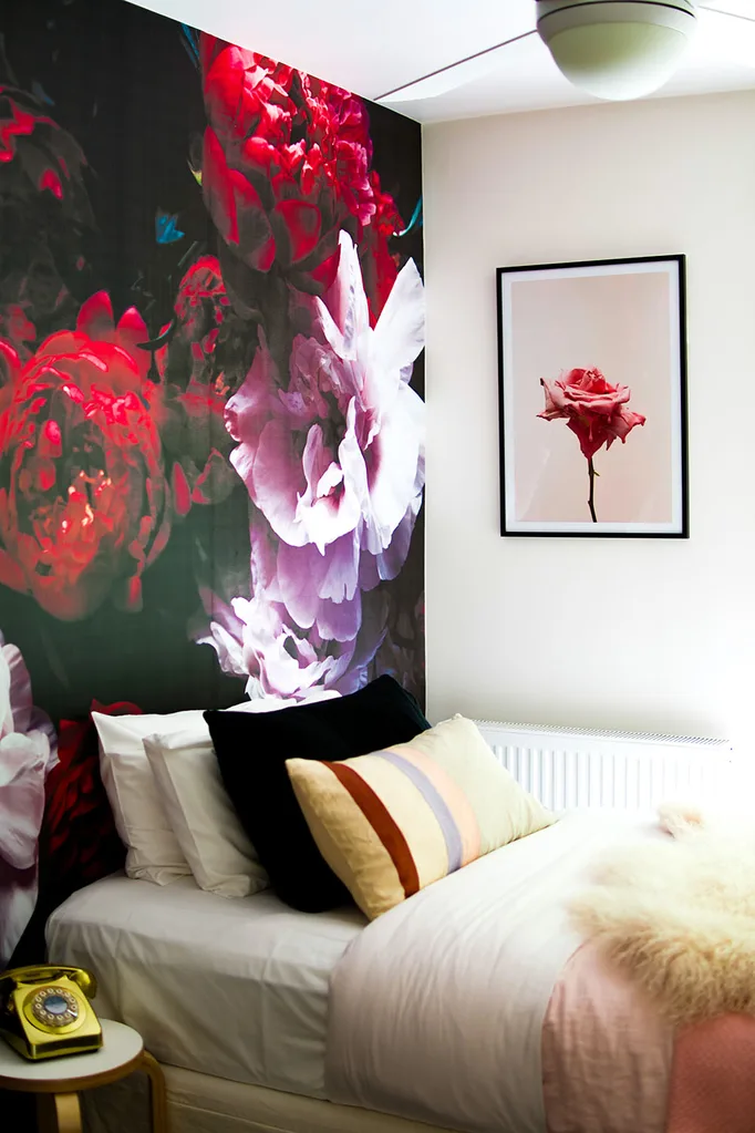A bedroom in Dollywood styled with floral wallpaper