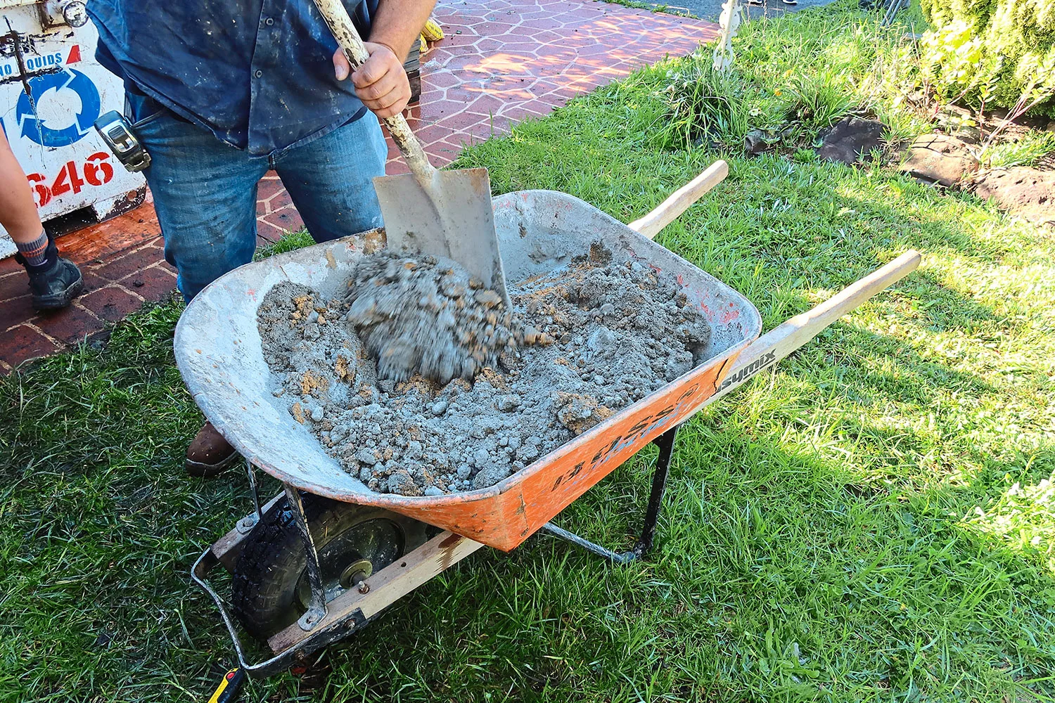 Mixing cement in a wheelbarrow