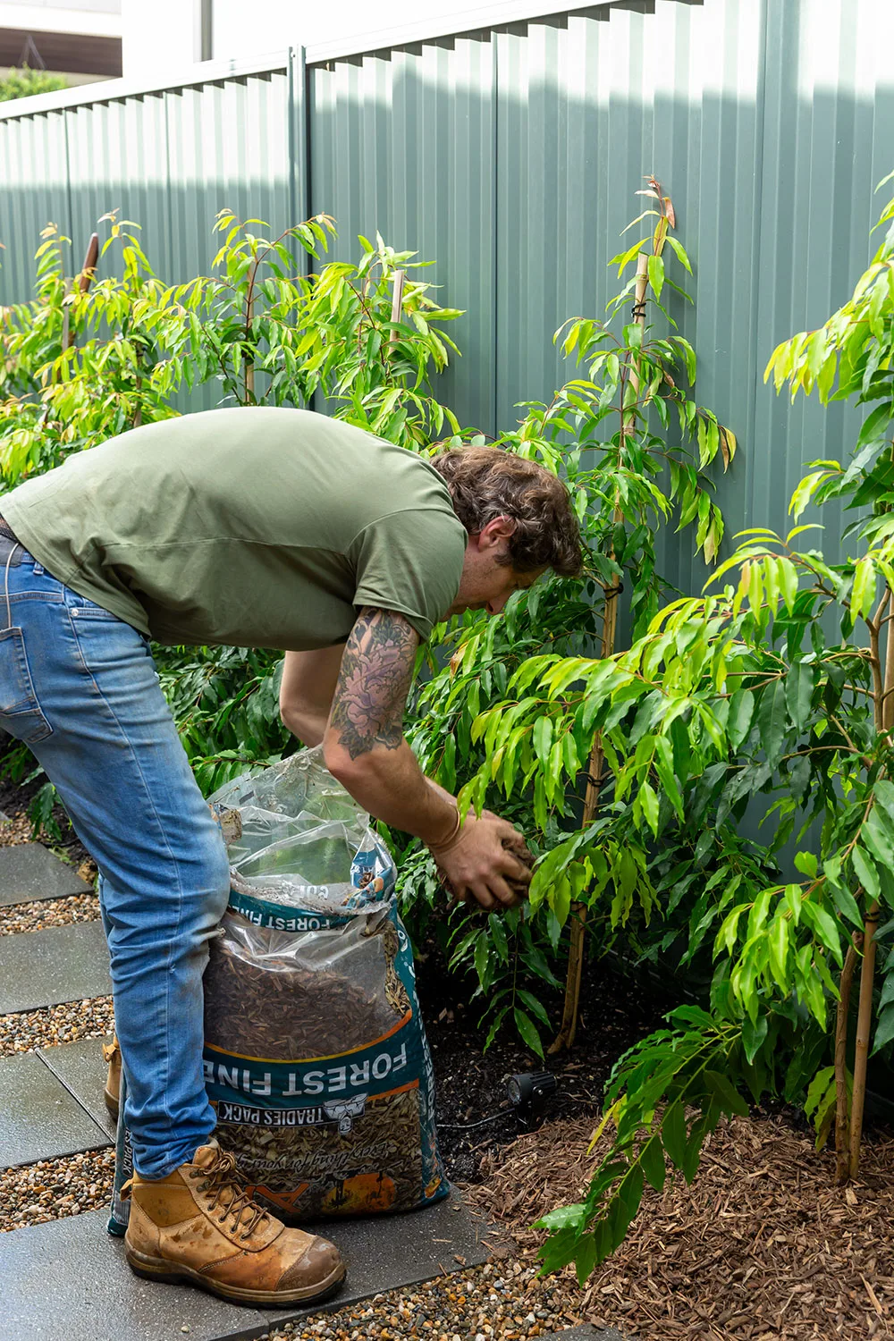 Charlie Albone spreading mulch