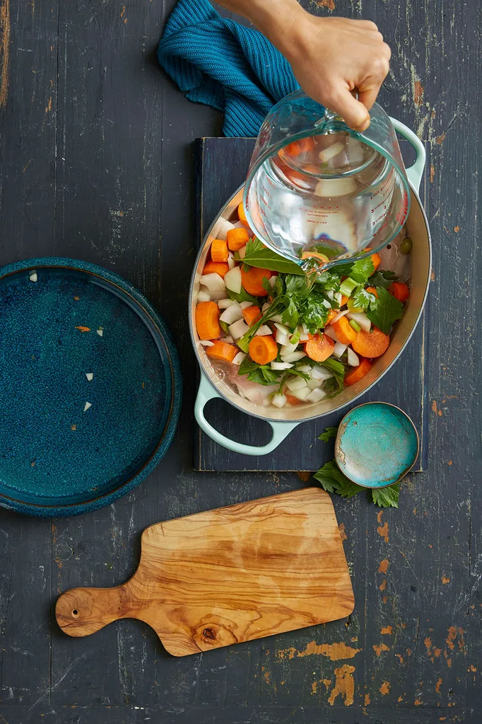 Add water to saucepin filled with vegetables and chicken