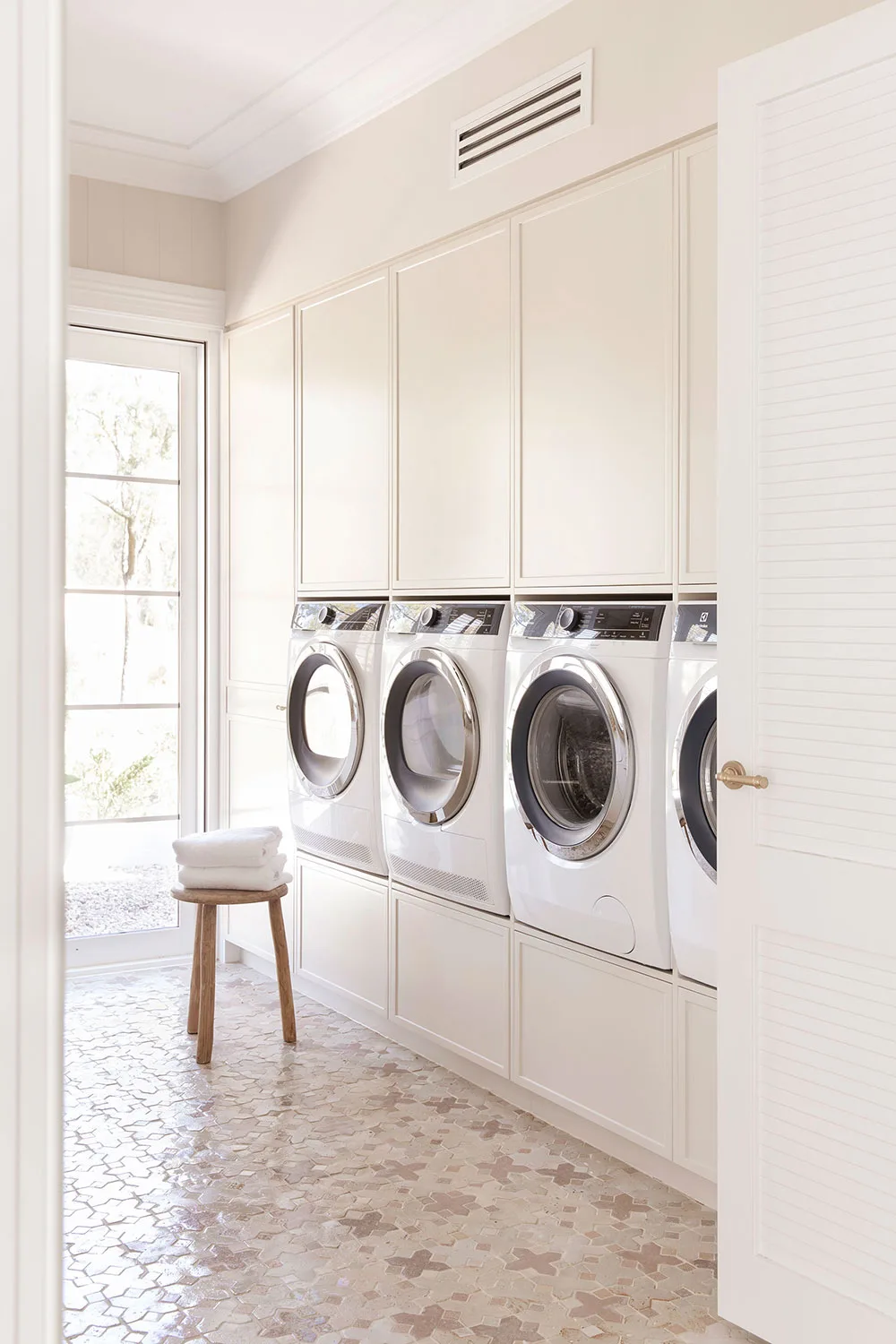 Cream coloured laundry with two washers and two dryers