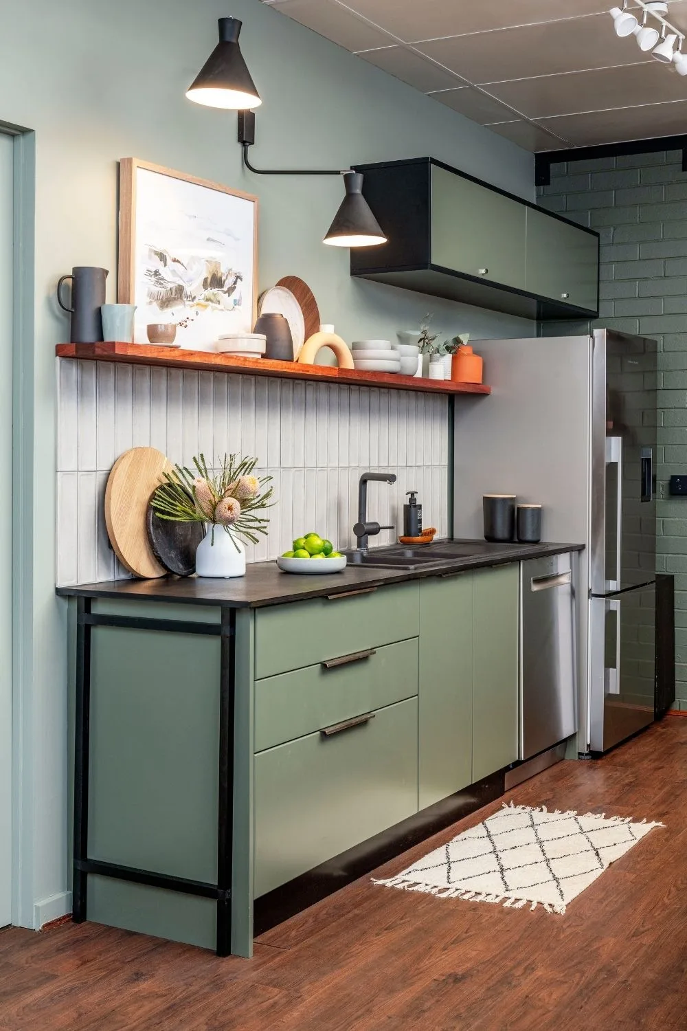 Green industrial-style kitchen with open shelving