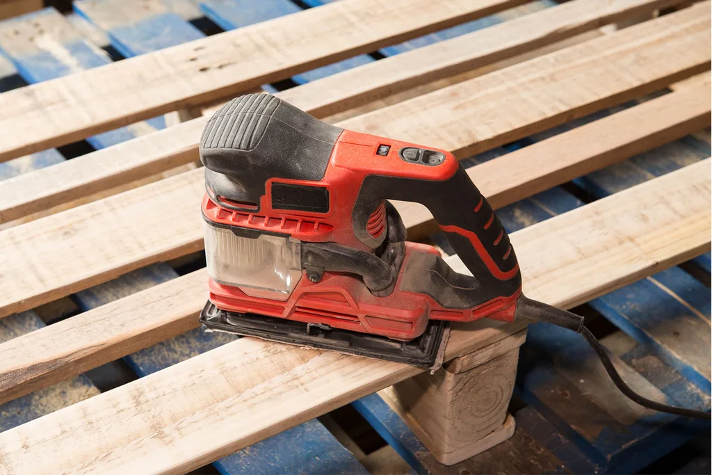 Staple gun sitting on top of timber pallet