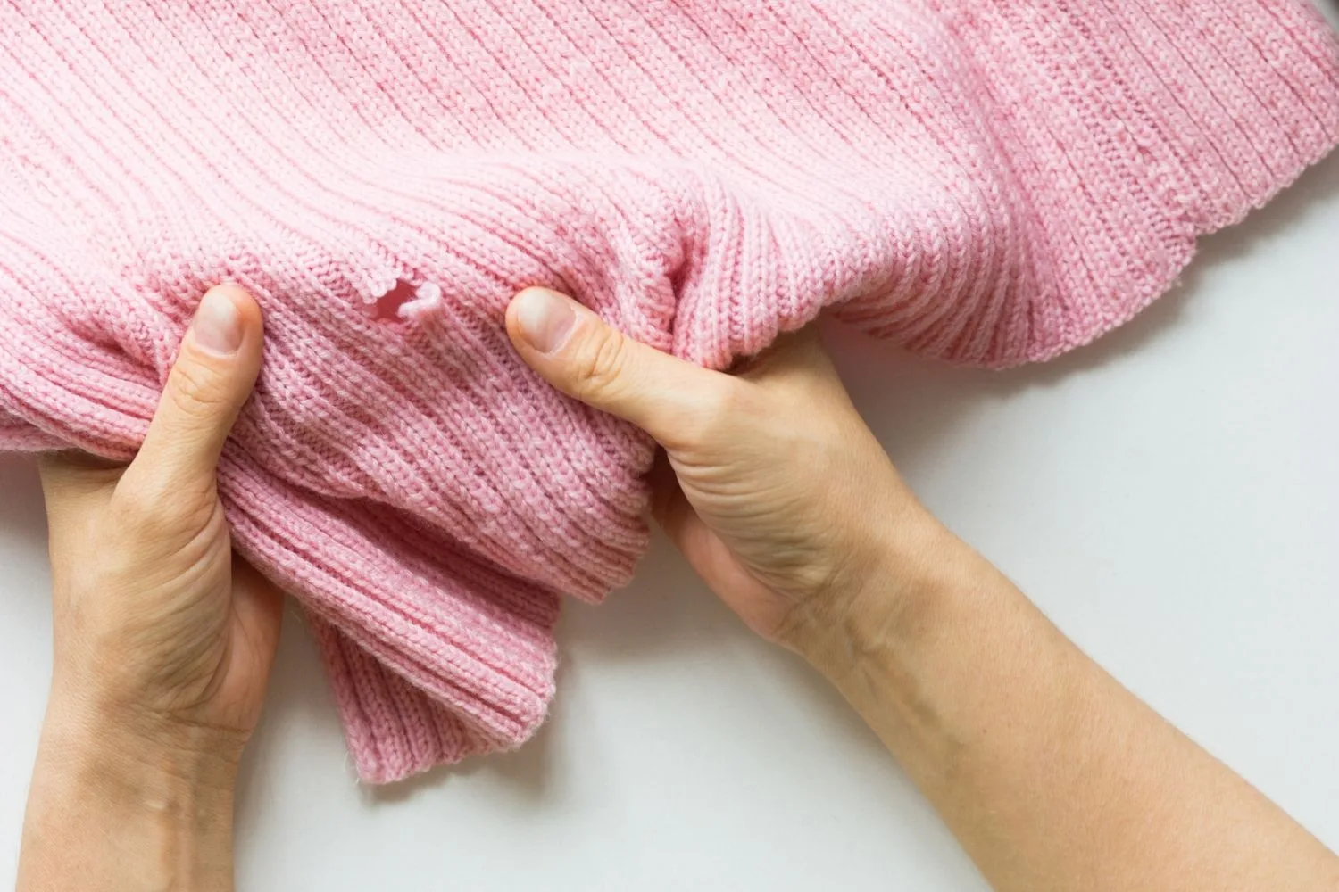 holes in pink jumper