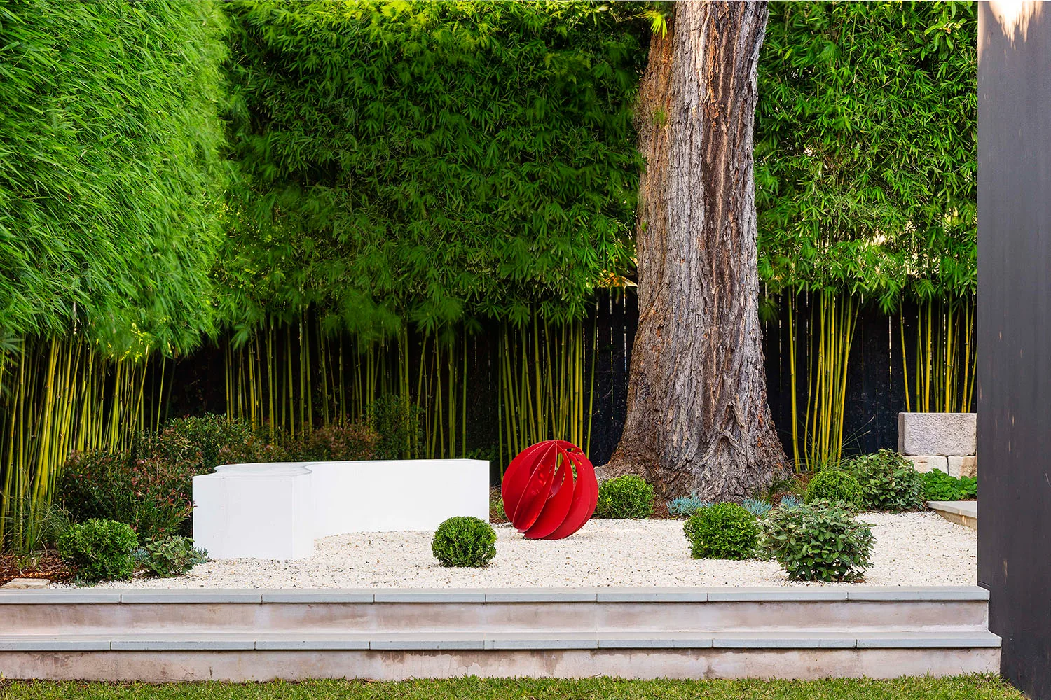 Red sculpture in a zen inspired garden