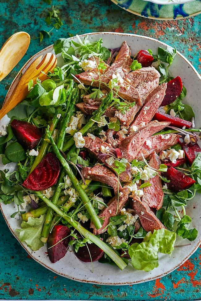 lamb steak on top of beetroot salad with rocket