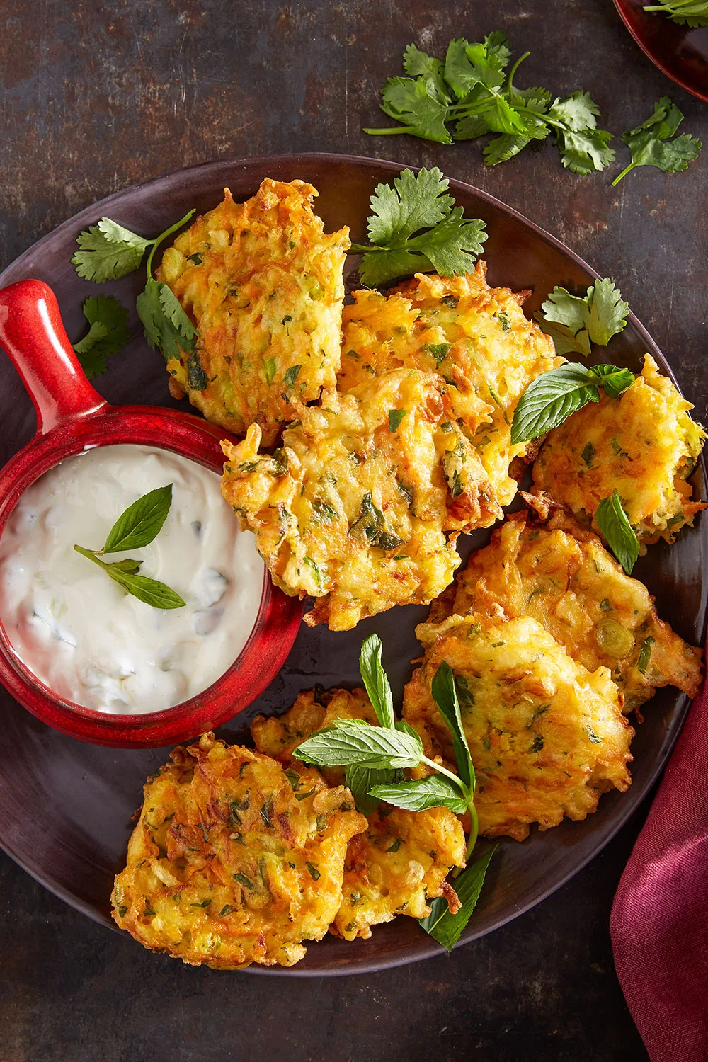 winter vegetable fritter recipe with yogurt sauce and mint on top