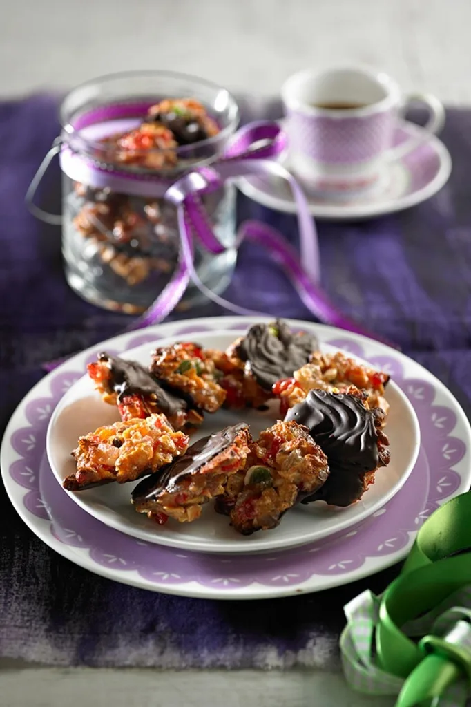 christmas florentines with dark chocolate base laid out in circular shape on plate
