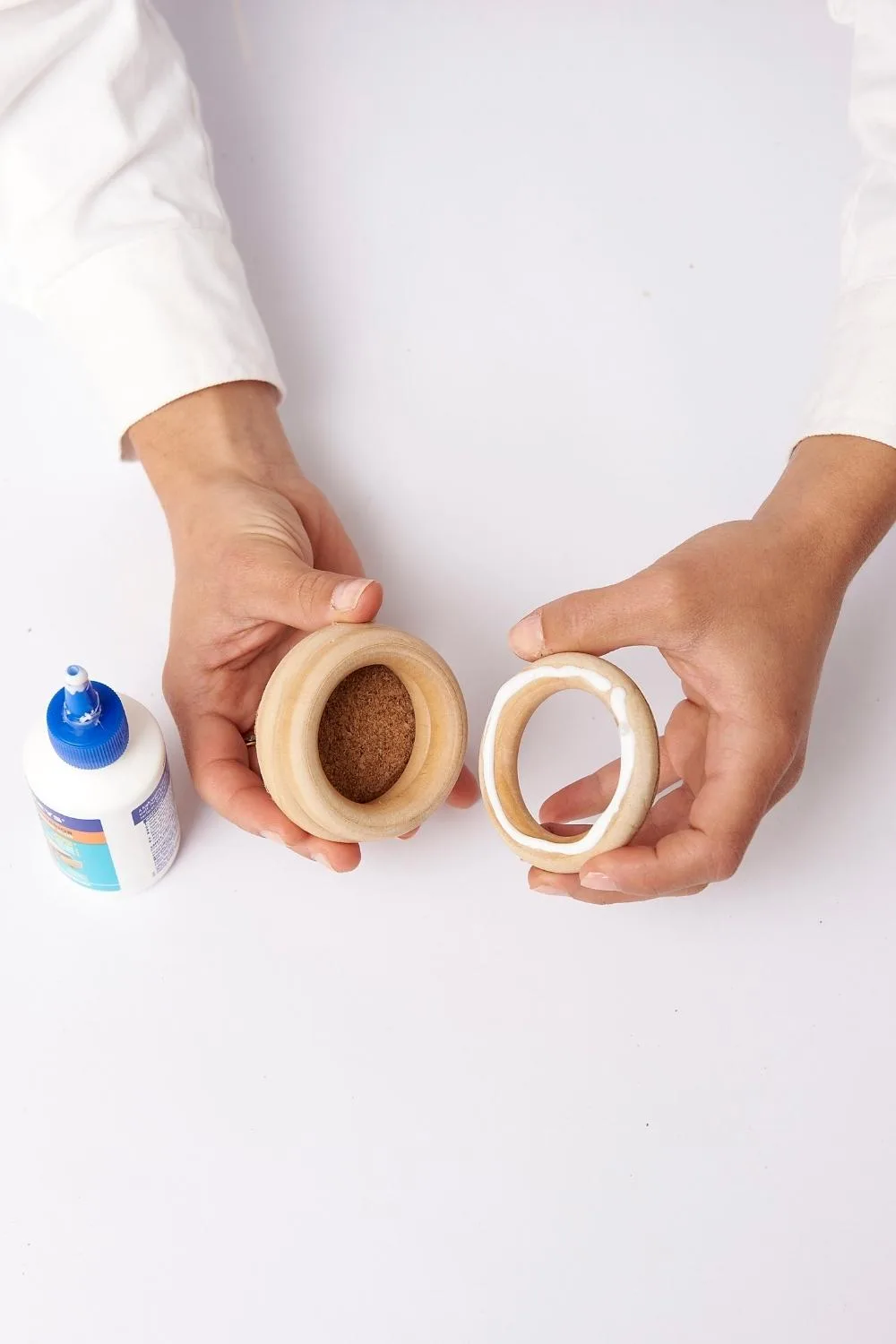 Apply PVA glue to one side of first curtain ring and position it on cork circle. Allow glue to set.
