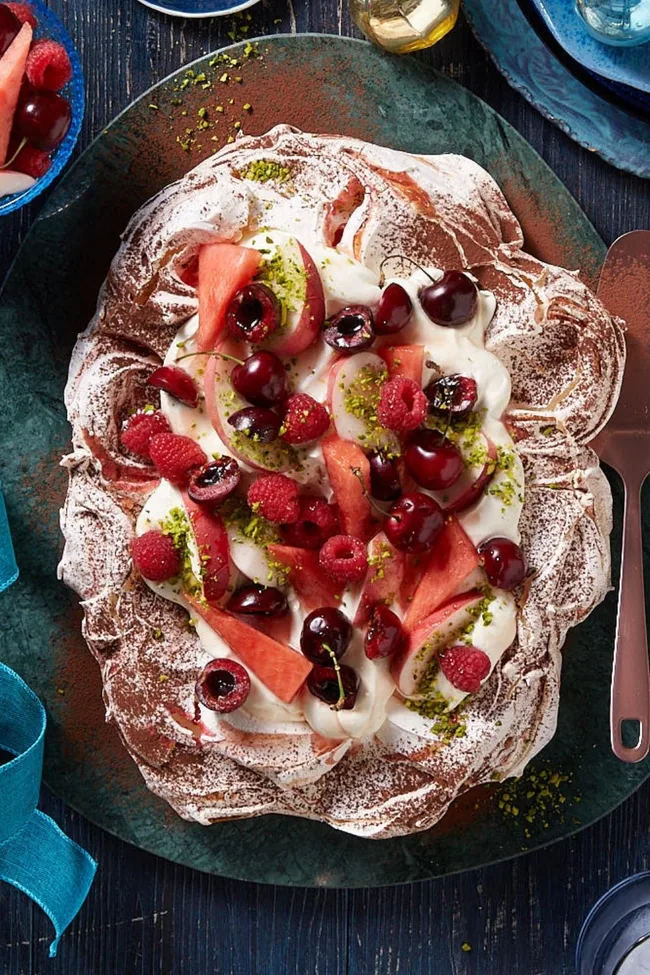 Pavlova with ice-cream and tipsy festive fruit salad