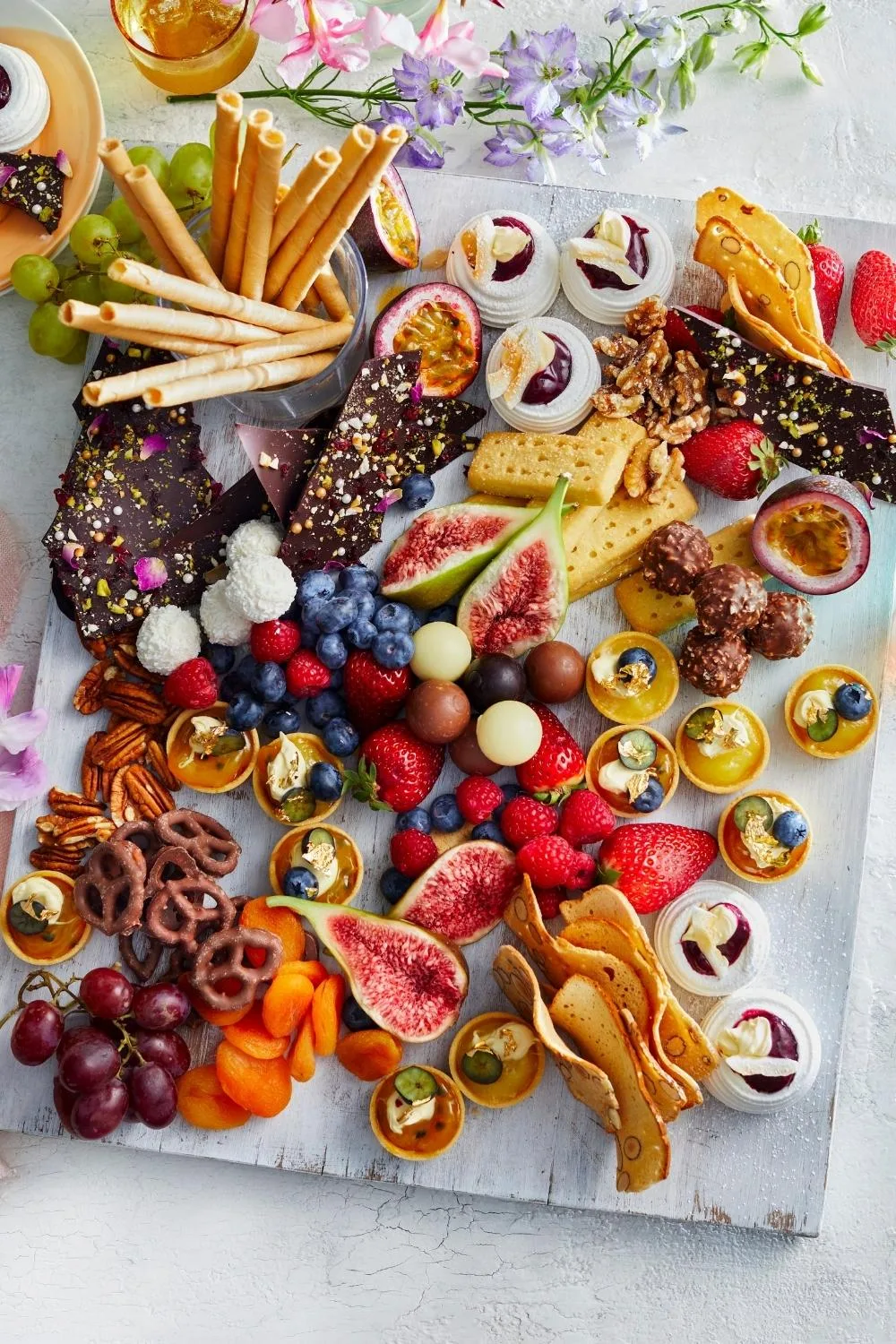 Luxe dessert platter with crackers, fruit, chocolate, nuts and mini desserts 