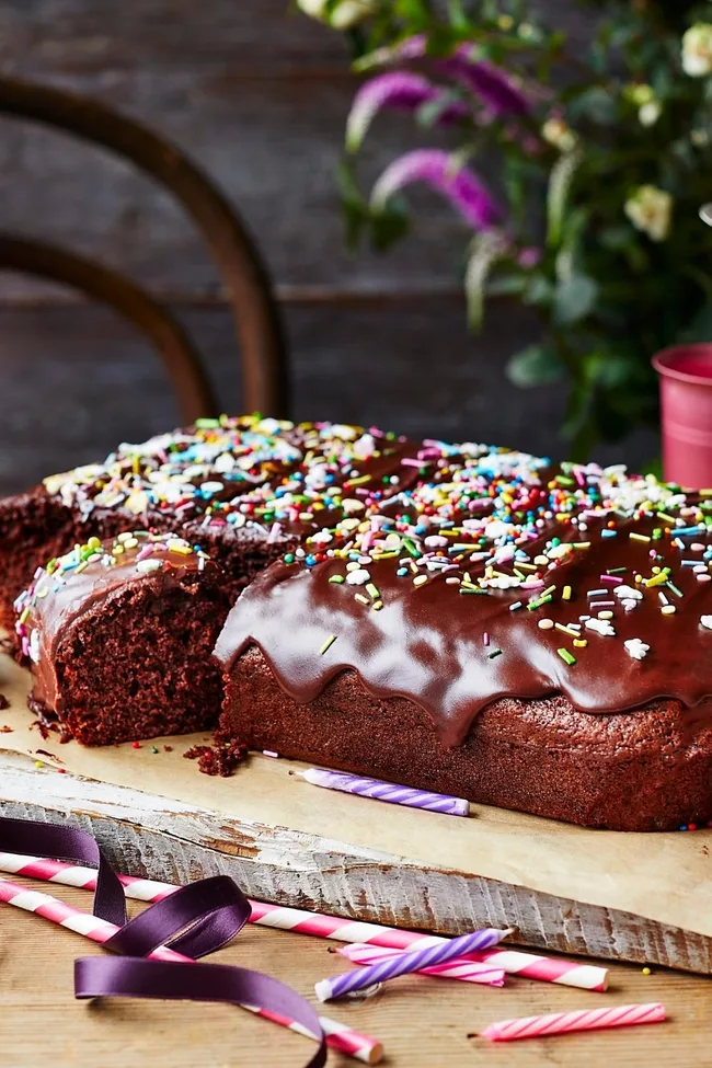 Chocolate cake tray bake with sprinkles and candles in front