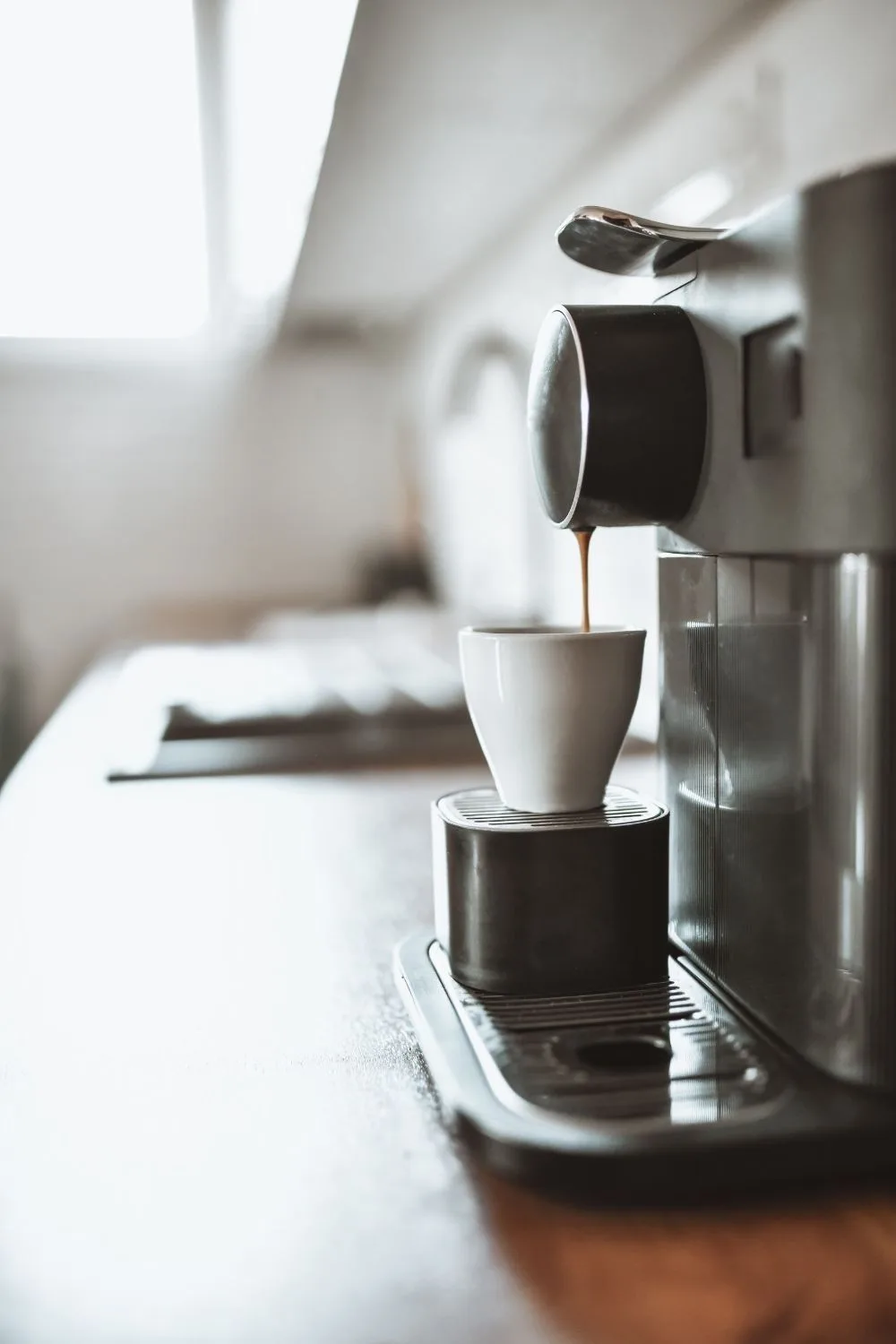 home-coffee-machine-extracting-coffee-into-mug