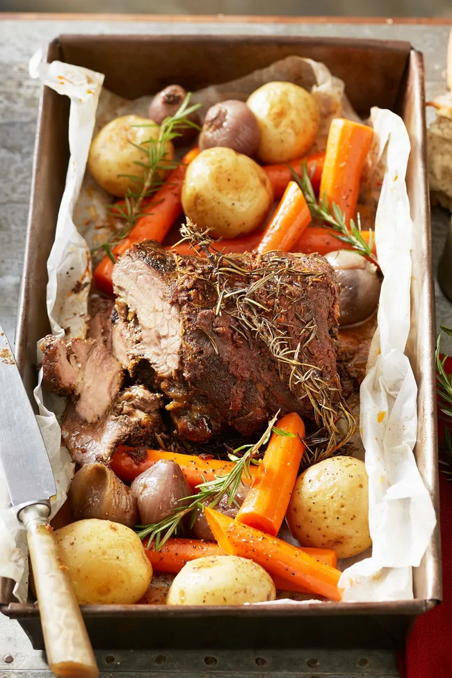 Slow cooked beef 'barbacoa' in oven tray with carrots and potatoes