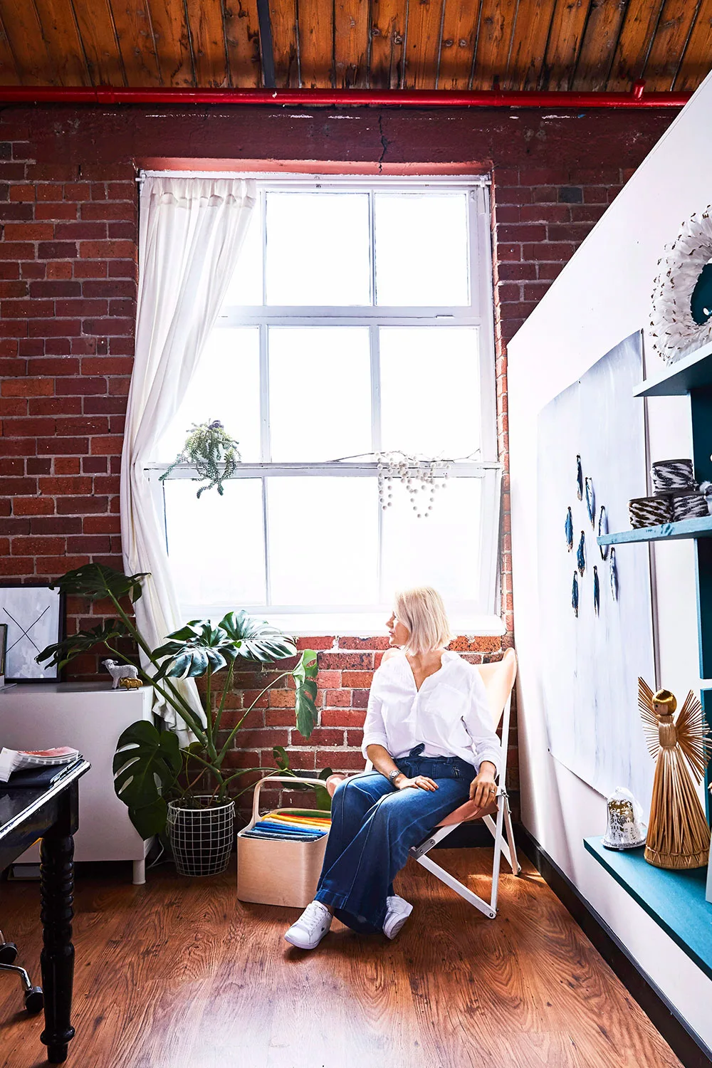 Woman sitting in front of window