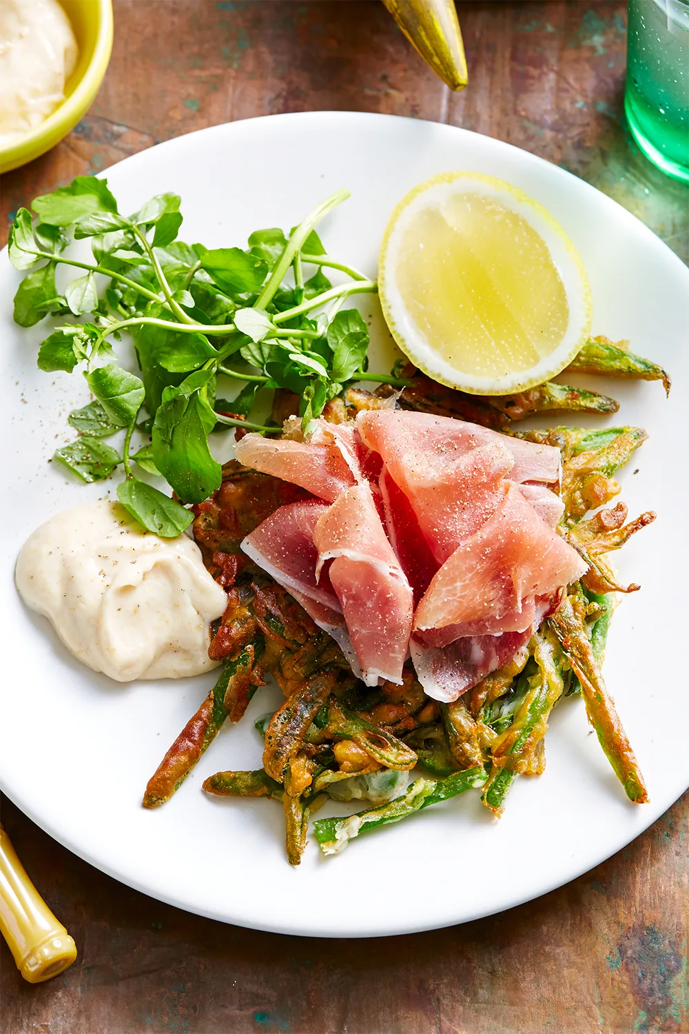 Corn fritters with hand‑cut ham and avocado and sprouts on the side