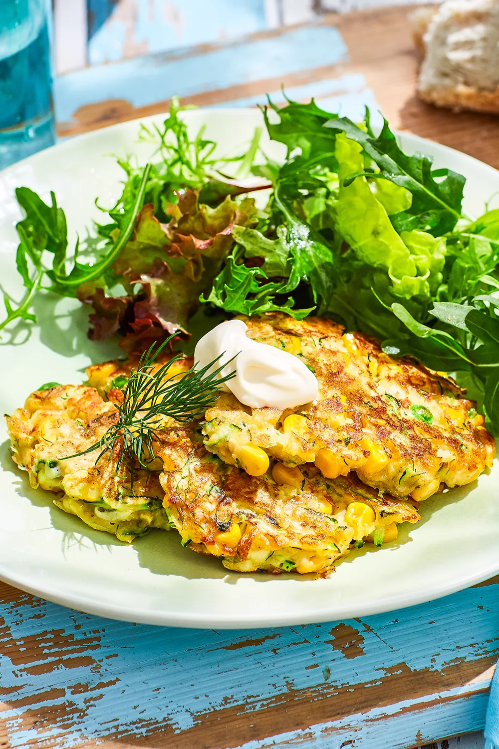 Zucchini, corn and dill fritters with fresh lettuce salad on the side