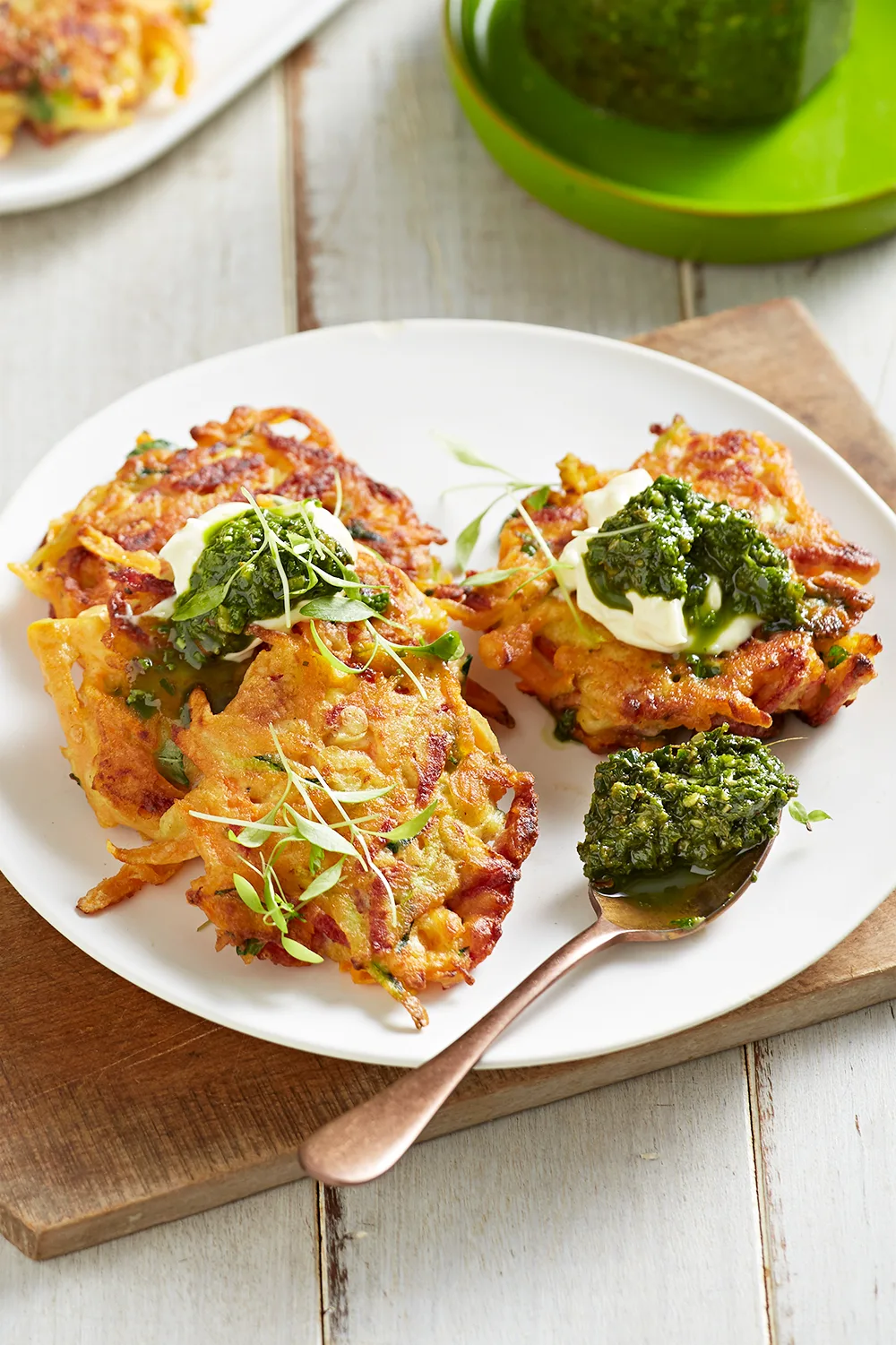 Sweet potato and salami fritters with pesto dolloped on top of best fritter recipes