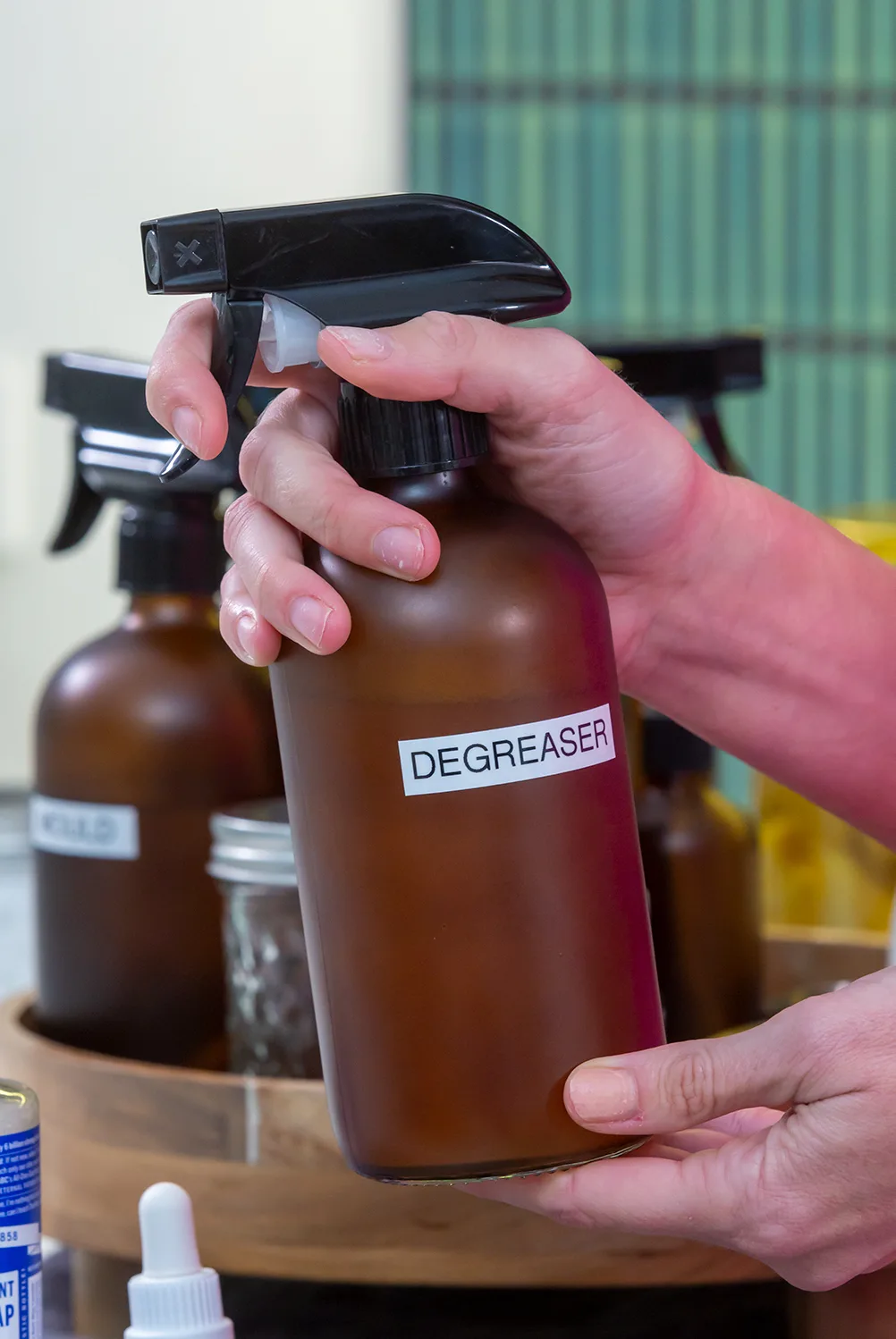 Make a spray that you can use as a degreaser but also to clean your countertops, inside the fridge and the stovetop. Pour 13/4 cups distilled water into a glass spray bottle. Add 2 tablespoons Castile soap and 20 drops of orange essential oil. Shake well before use.