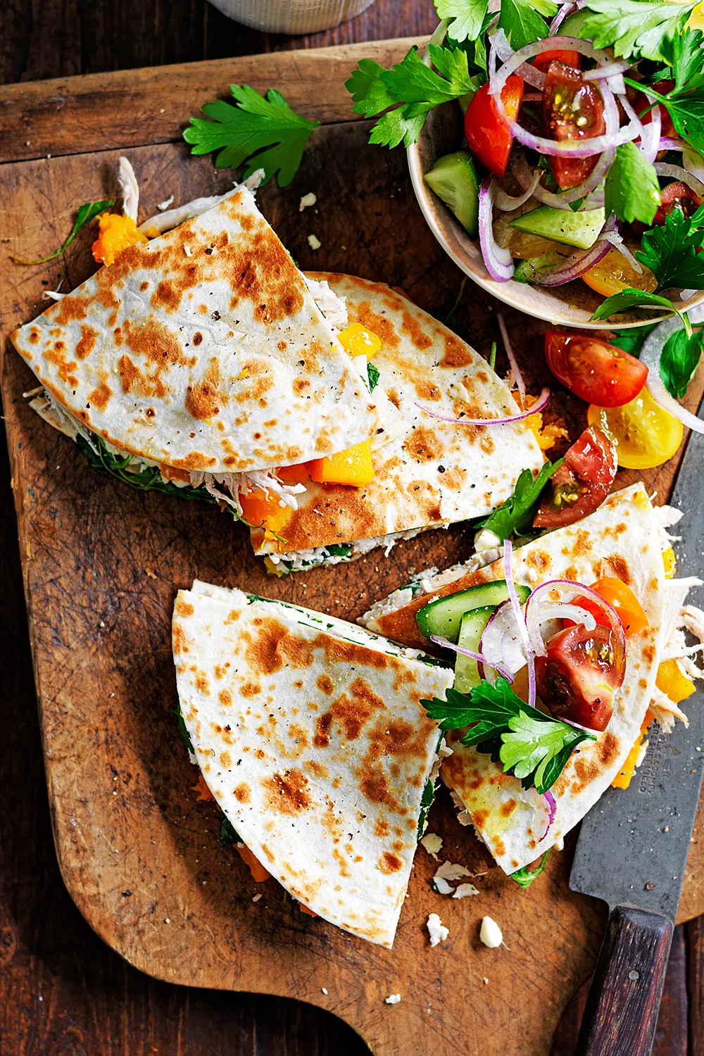 Pumpkin, chicken and feta quesadillas on a wooden tray made with leftover roast chicken