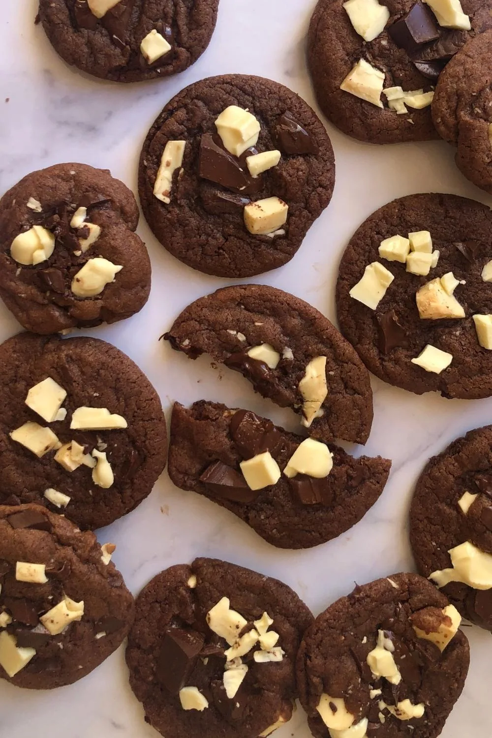 close up of chocolate cookies with white chocolate chunks on the top of them