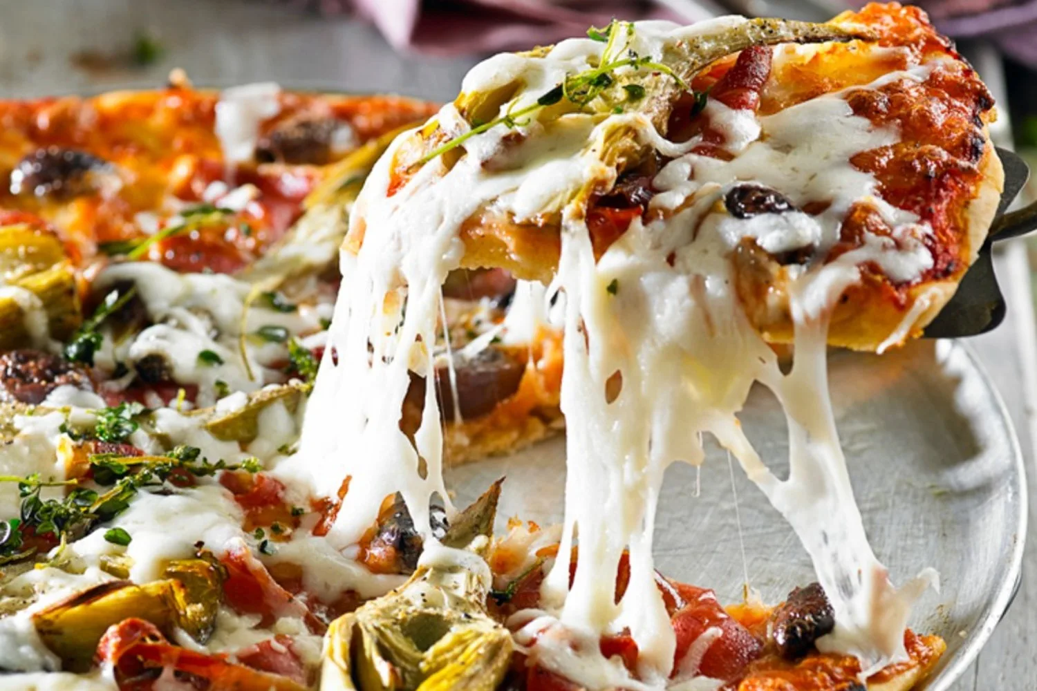 Gluten-free prosciutto, mozzarella and artichoke pizza