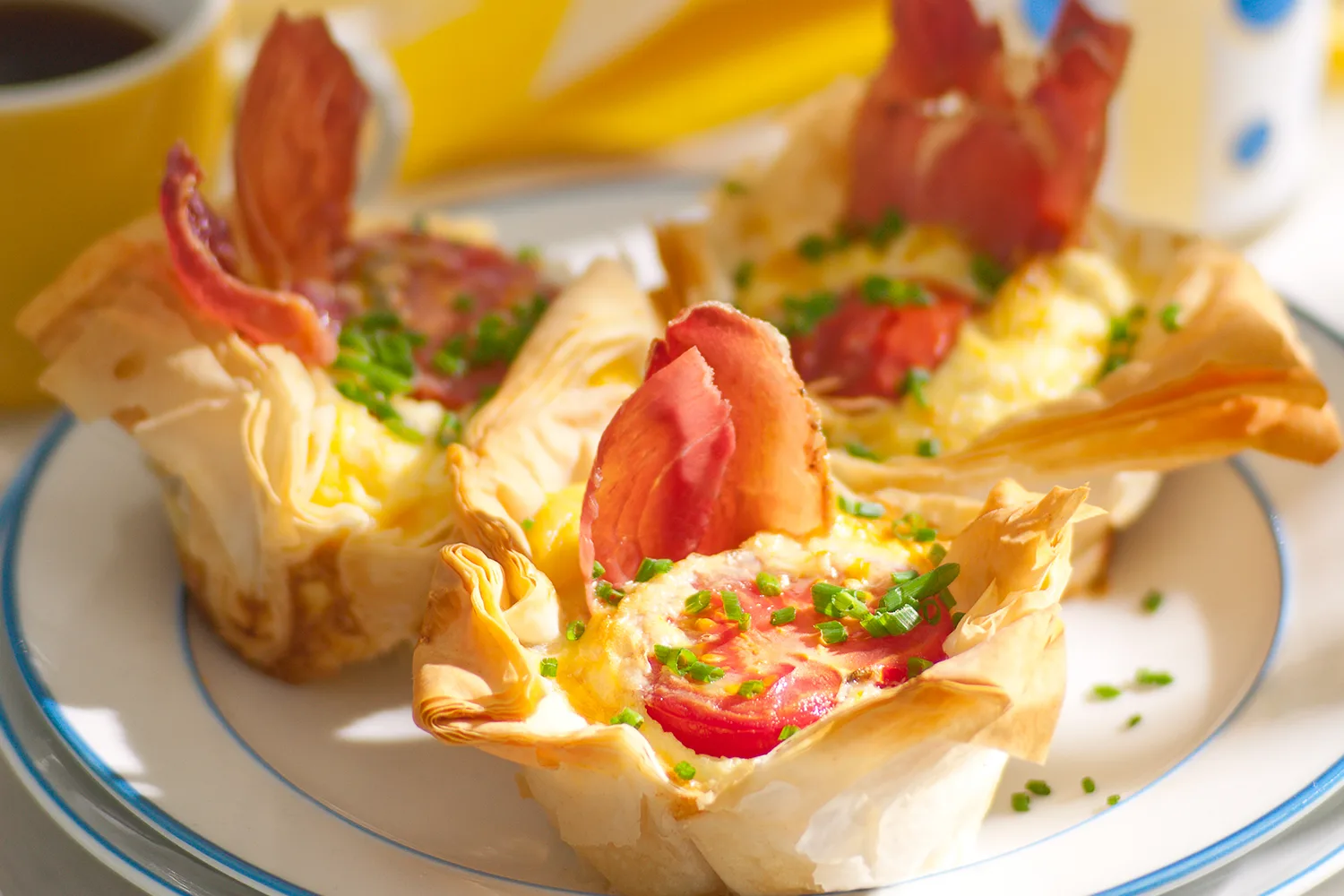 Mini filo quiches with prosciutto, tomato and crème fraîche