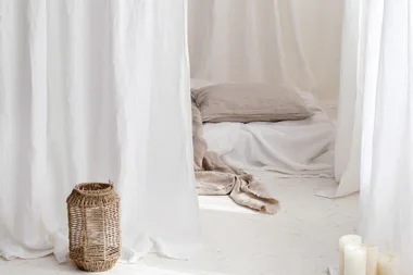White linen curtains to create a luxurious oasis in your bedroom