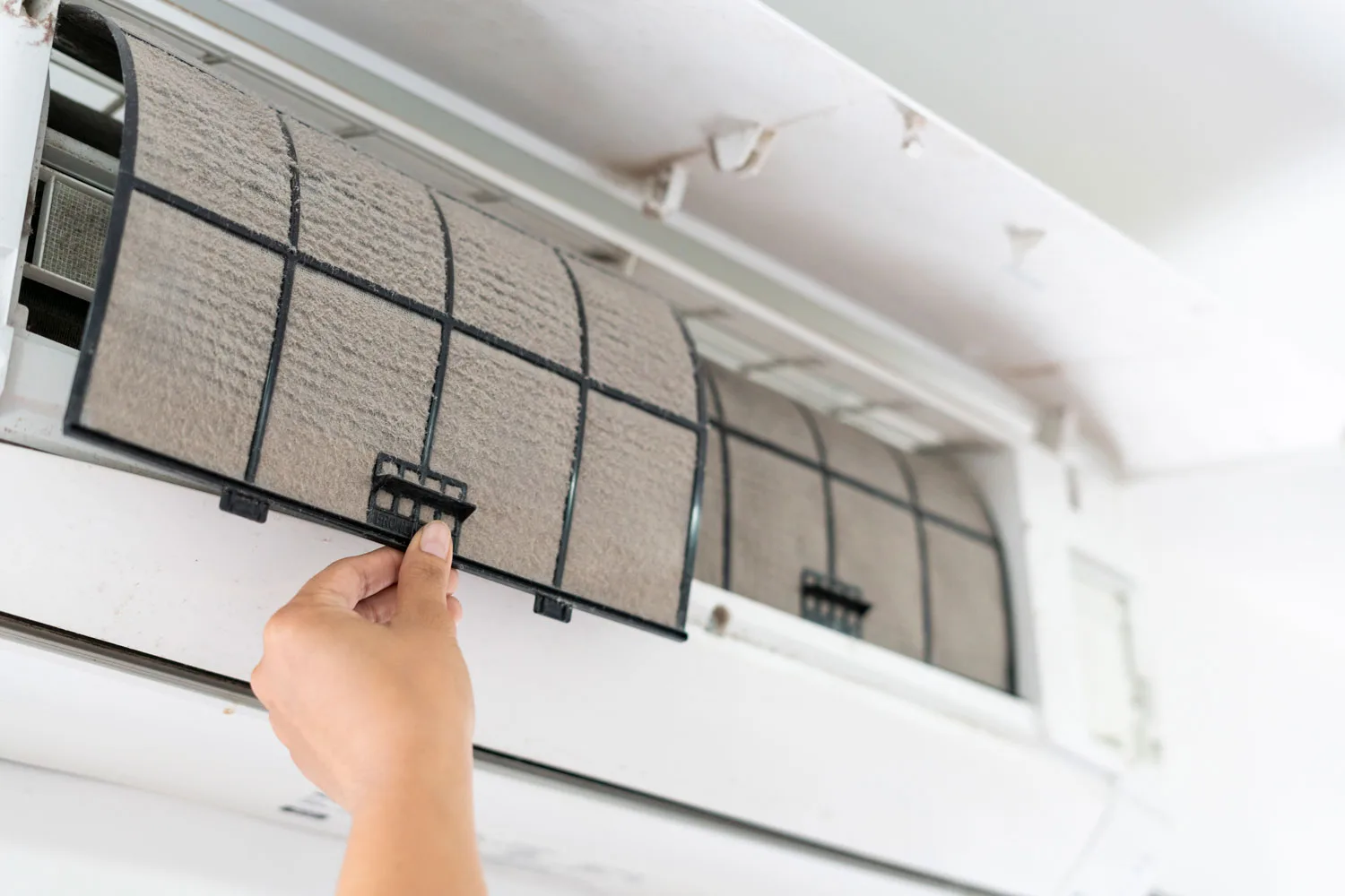 air conditioner fliter being cleaned