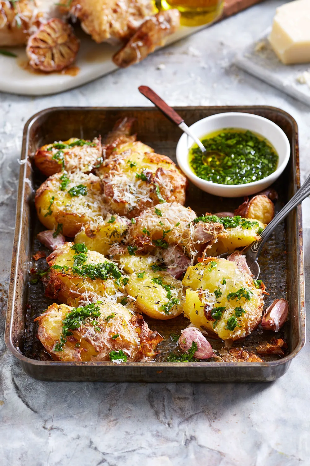 Smashed parmesan potatoes with herb oil