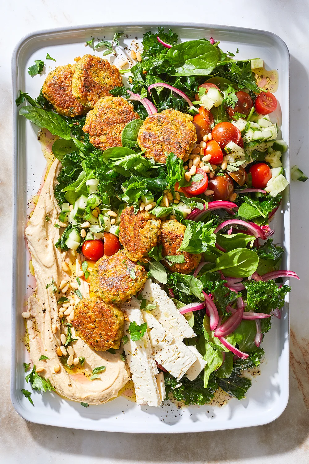 Kale falafel salad with toasted pine nuts and hummus