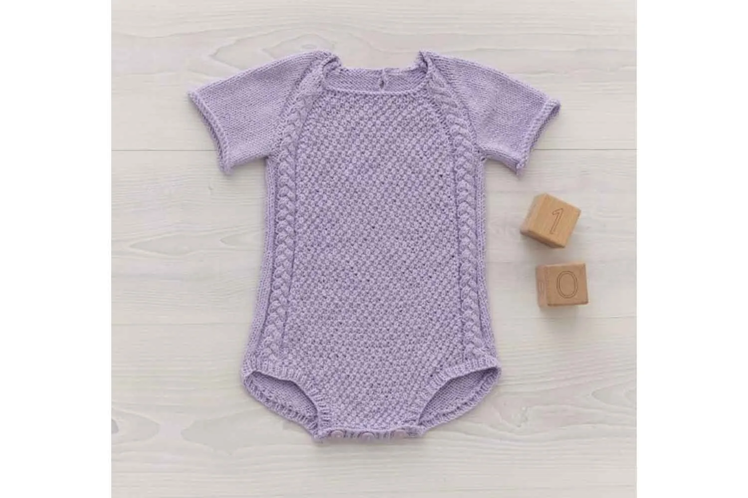 Patons cable romper free knitting pattern for babies.