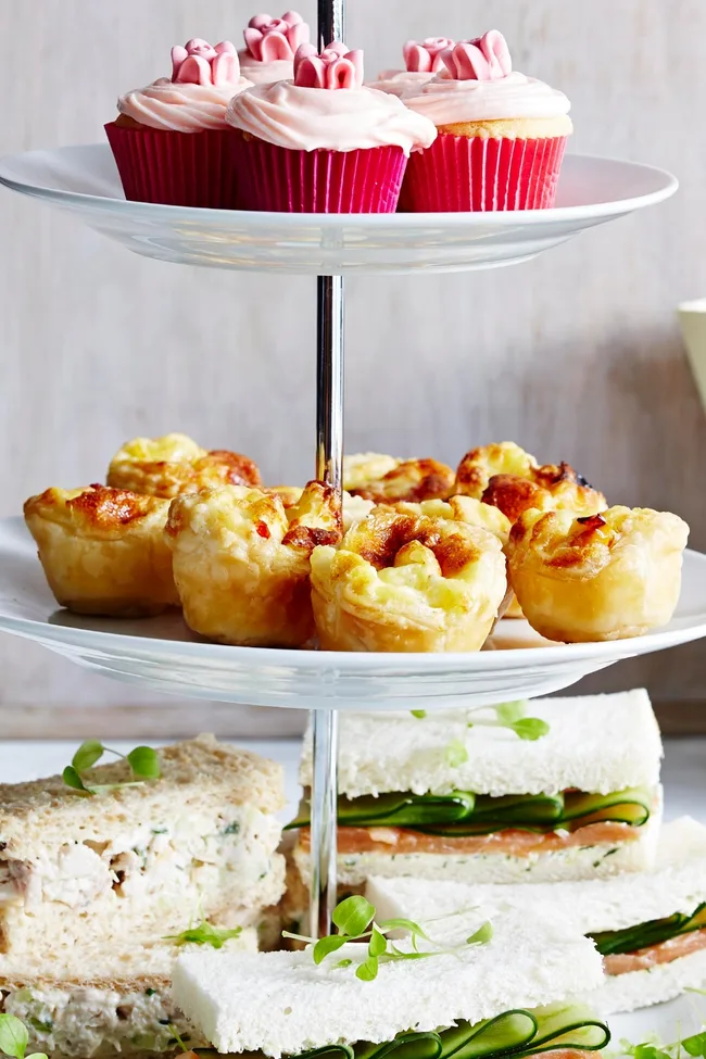Mini quiche puffs on a tiered cake stand ready for high tea