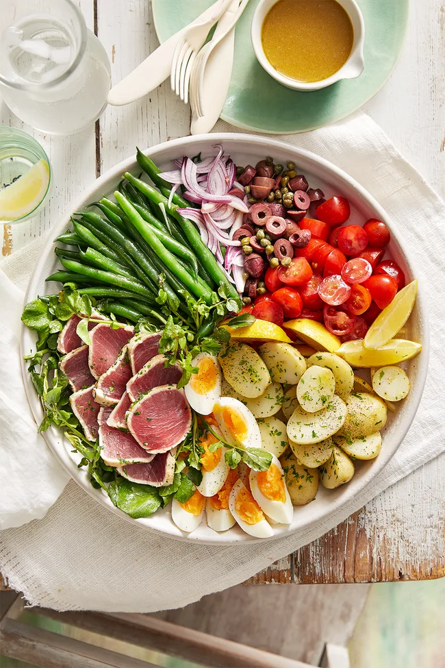 nicoise salad laid out with each ingredient in it's own section of the bowl