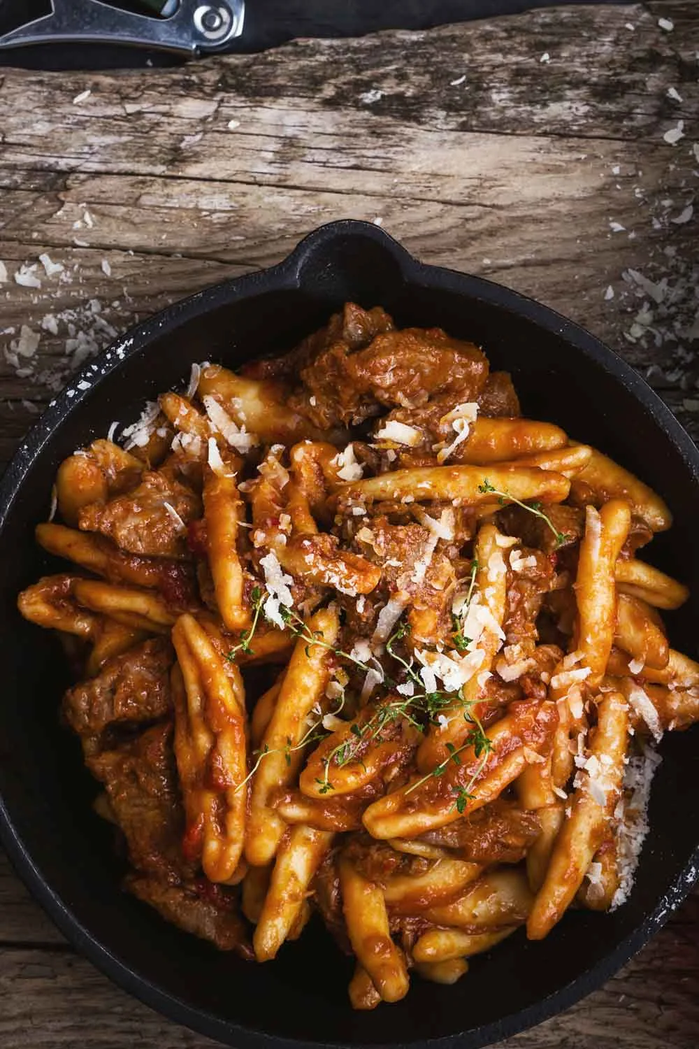pasta cooked in a cast iron pan that needs cleaning