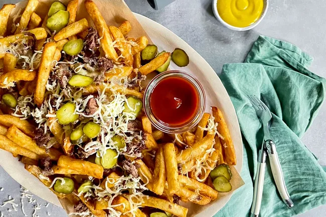 loaded cheeseburger fries on a serving platter