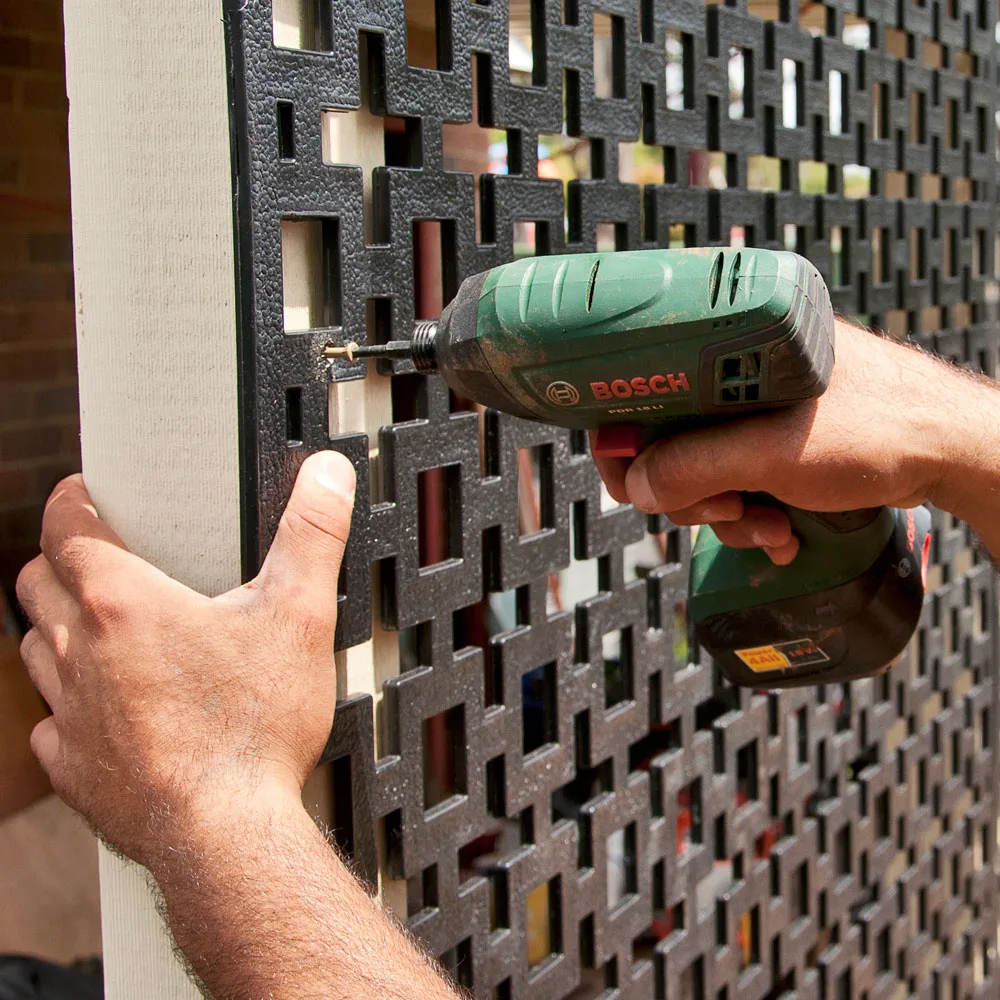 Using a nail gun, skew nail rails in place on your privacy screen.