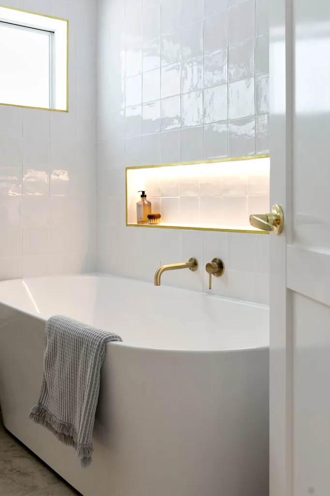White bathroom with recessed lighting niche