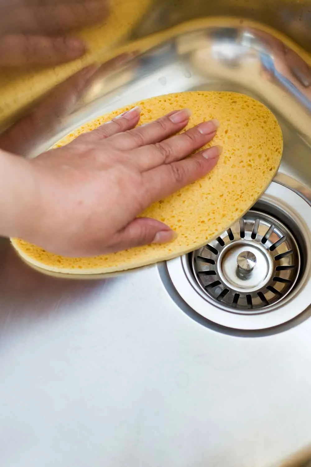 cleaning a sink making it shiny