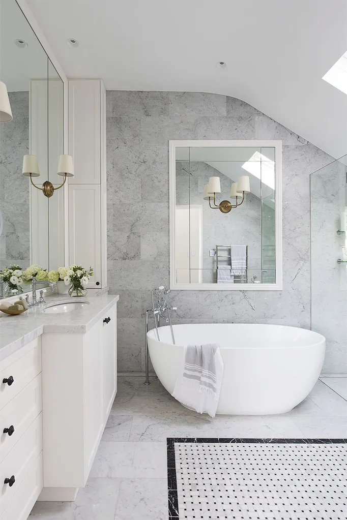 Marble bathroom with bath tub and rug