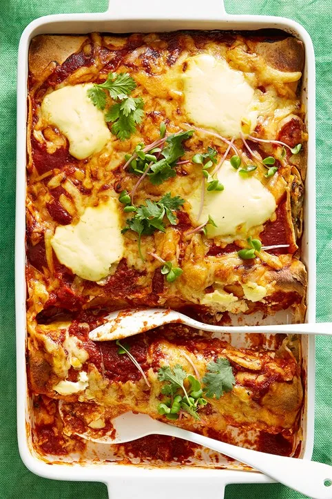 rice and beef enchiladas with spoon in the middle