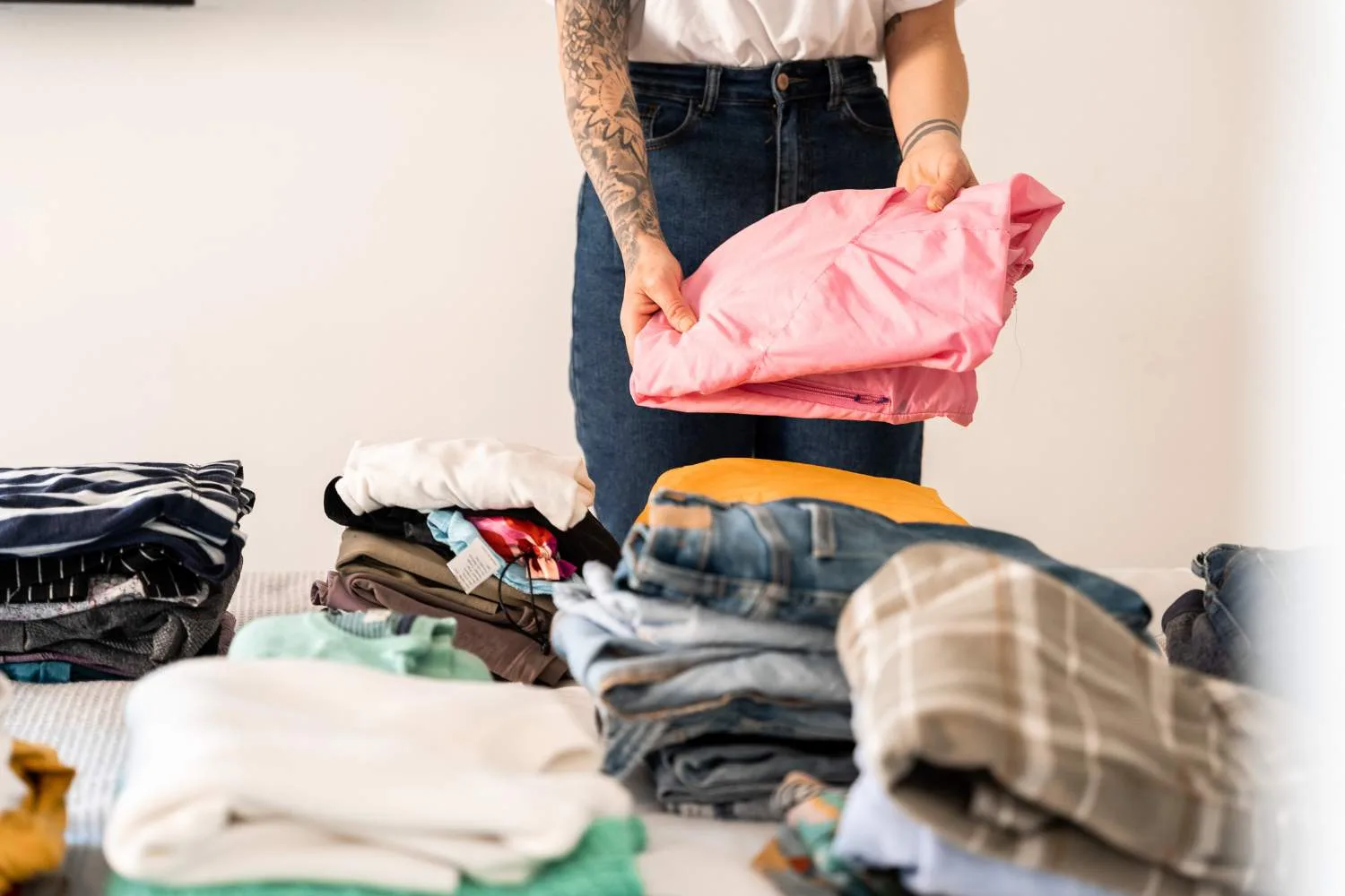 folding clothes on a bed