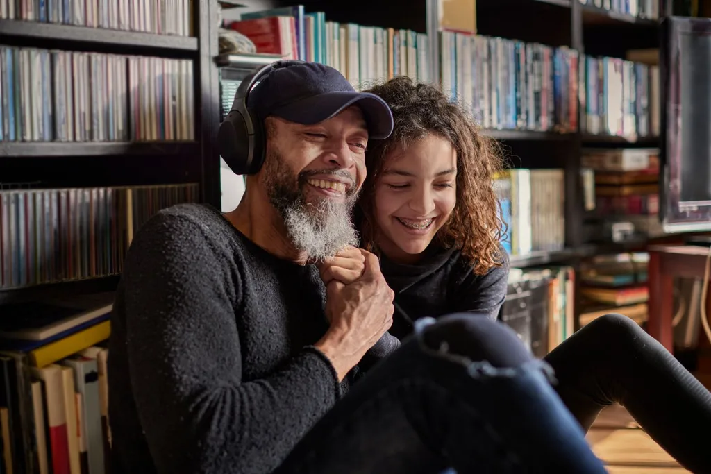 Father and daughter listening to music